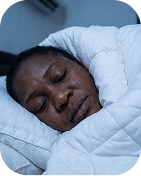 Woman sleeping peacefully under a duvet
