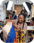 Woman working with colorful fabric at a sewing desk