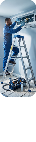 Electrician working on a ladder near an AC unit