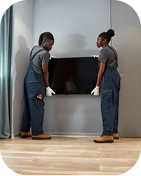 Movers carrying a TV into a living room