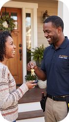 Homeowner handing over keys to an artisan at the front door